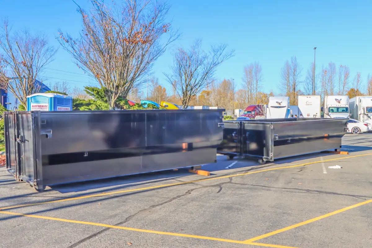 Professional dumpster rental service with roll-off container on residential driveway in Pinellas Park